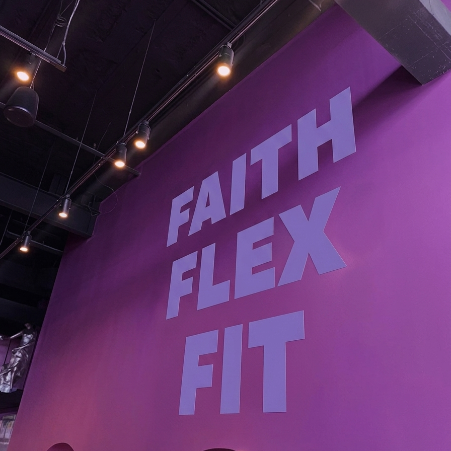 Purple wall with 'FAITH FLEX FIT' text in a gym setting