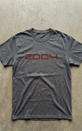 Gray t-shirt with 'Since 2004' text on a concrete floor